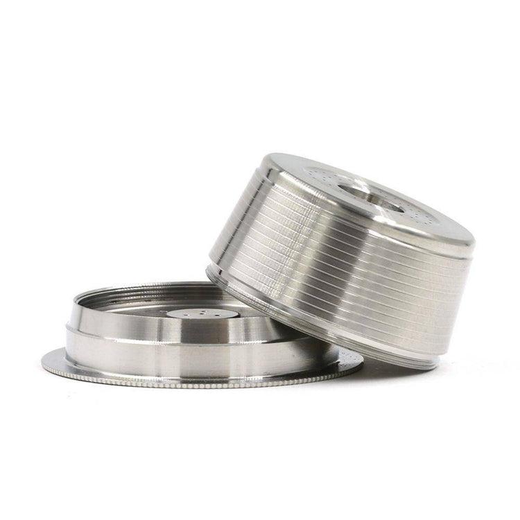 A single reusable stainless steel coffee capsule compatible with Aldi K-Fee, Caffitaly or Verismo machines, close up apart.