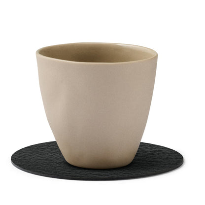 Circle recycled leather coaster featuring the signature LIND DNA buffalo texture with a ceramic cup.