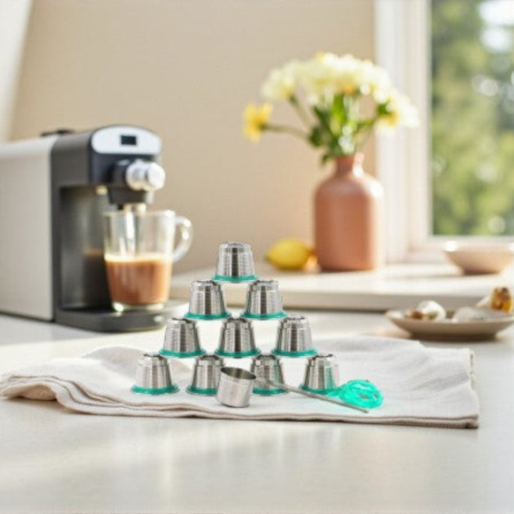 Set of Pod Star Nesspresso Original reusable stainless steel coffee pods  on a kitchen bench with coffee machine in the background
