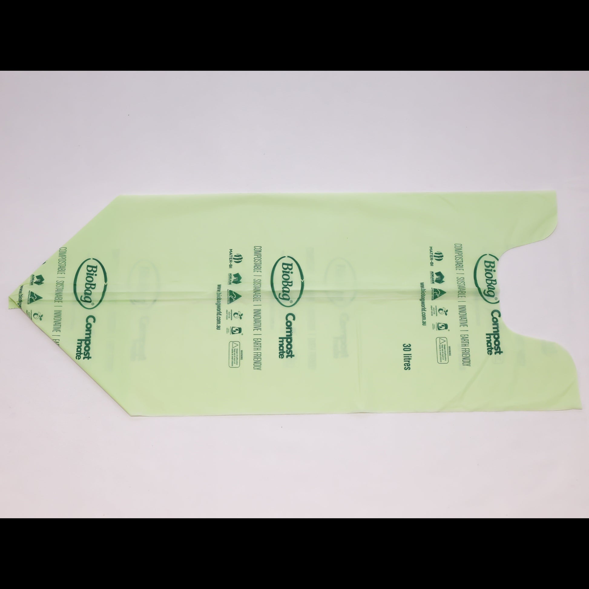 Close up of Compost Mate bio-plastic liner roll highlighting official AS5810 home compostable and AS4736 commercial compostable certifications 30 litre unrolled.