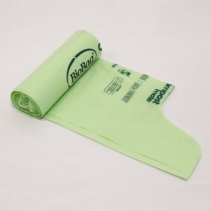 Close up of Compost Mate bio-plastic liner roll highlighting official AS5810 home compostable and AS4736 commercial compostable certifications showing wave top.