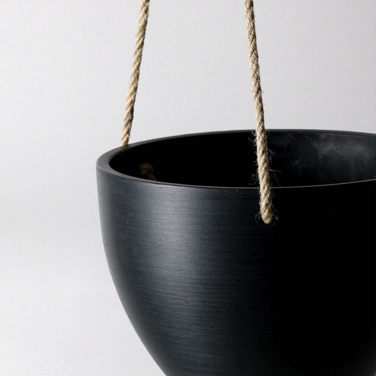 Single Columbia recycled plastic hanging planter bowl in black showing a close up of the hemp rope and smooth texture.