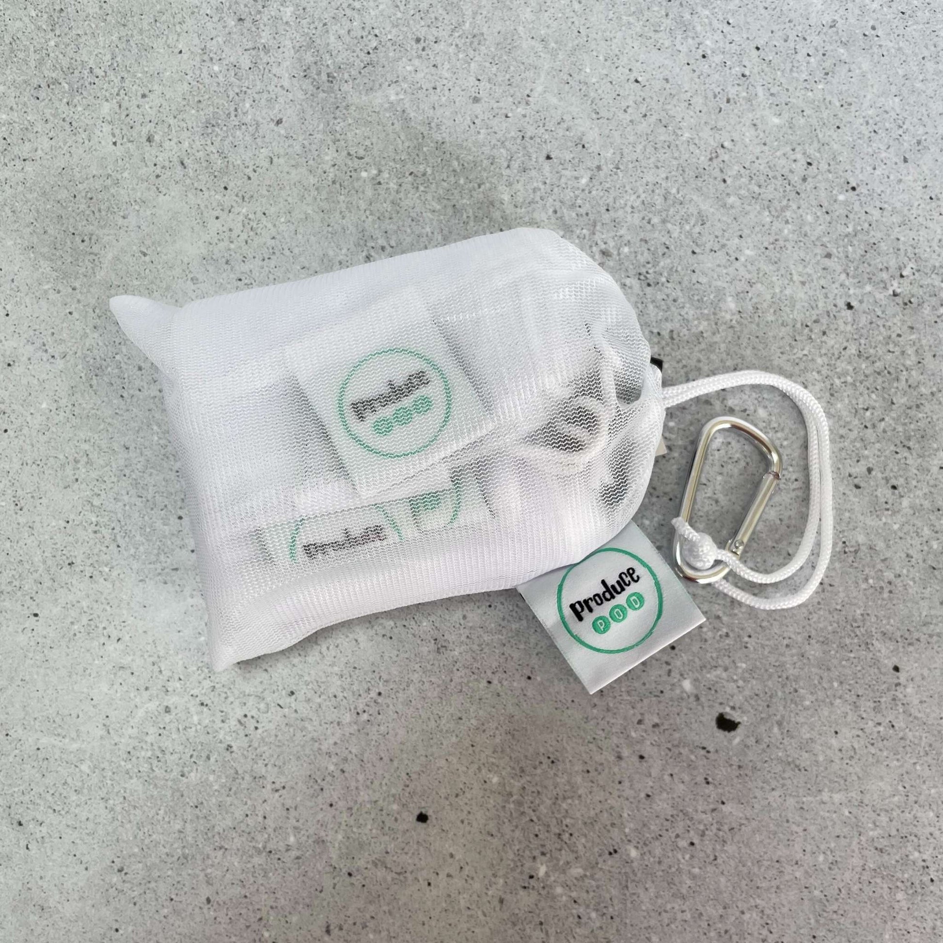 Multi pack mesh produce sleeves placed directly inside a large Produce Pod storage bag, demonstrating seamless zero unpack fridge organisation.