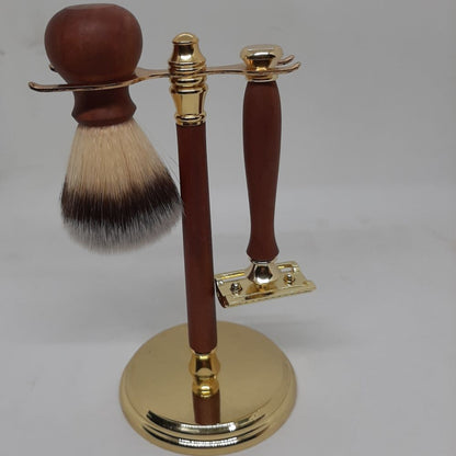 A premium 3-piece men's grooming kit featuring a hand-turned recycled timber safety razor and matching shave brush resting on an organized wooden stand, handcrafted in Australia in gold.