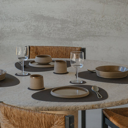 Curve recycled leather placemats featuring the signature LIND DNA corduroye texture on a table set for four with plates, cutlery and glassware.