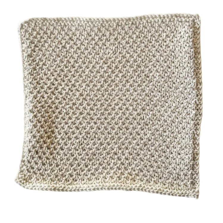 Cream handmade knitted dishcloth made from absorbent recycled cotton for kitchen and bathroom use on a white background.