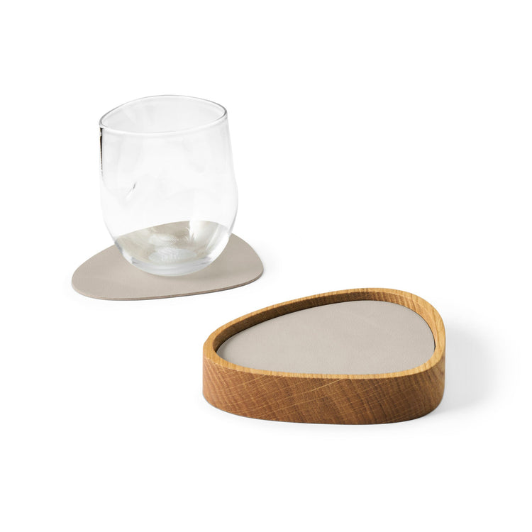 Curve recycled leather coaster box with coasters with a single coaster and glass showing LIND DNA texture.