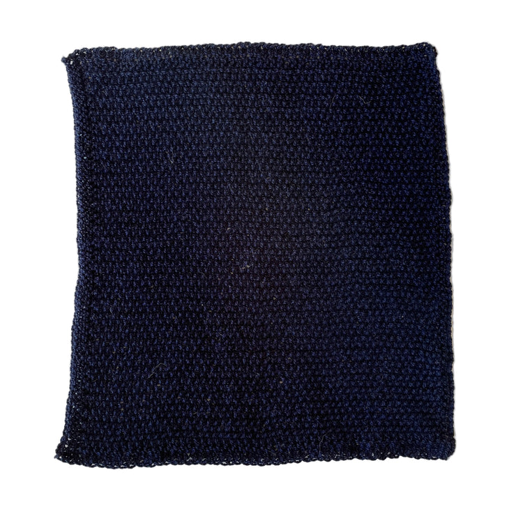 Dark blue handmade heavy-duty acrylic scrubbing cloth made from salvaged yarn mill ends for tough kitchen cleaning.