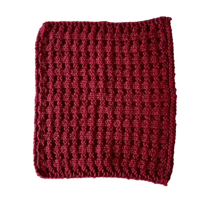 Dark red handmade knitted dishcloth made from absorbent recycled cotton for kitchen and bathroom use.