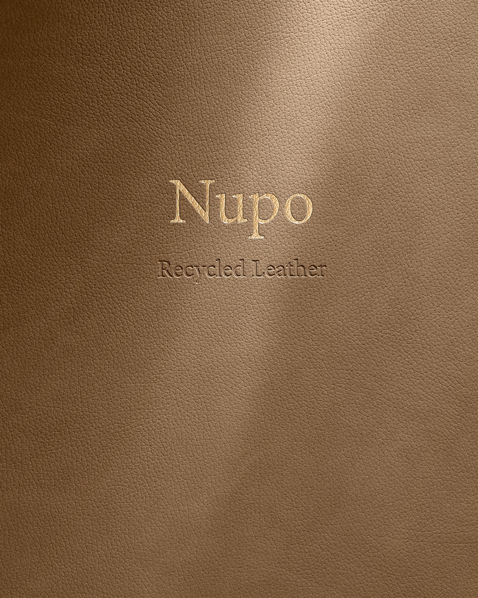 Brown leather surface with 'Nupo Recycled Leather' embossed text