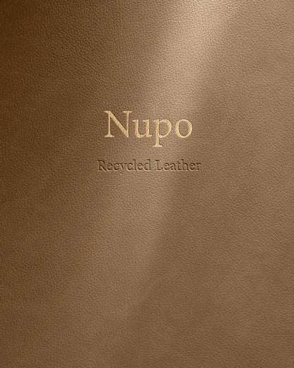 Brown leather surface with 'Nupo Recycled Leather' embossed text