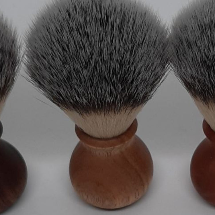 Close-up of the ergonomic wooden handle and high-quality synthetic bristles of a sustainable shaving brush made in Jindera, New South Wales.