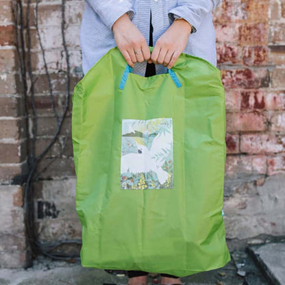 Shopper using a durable and spacious Onya reusable bag to pack fresh market groceries during a zero waste shopping trip in Melbourne.