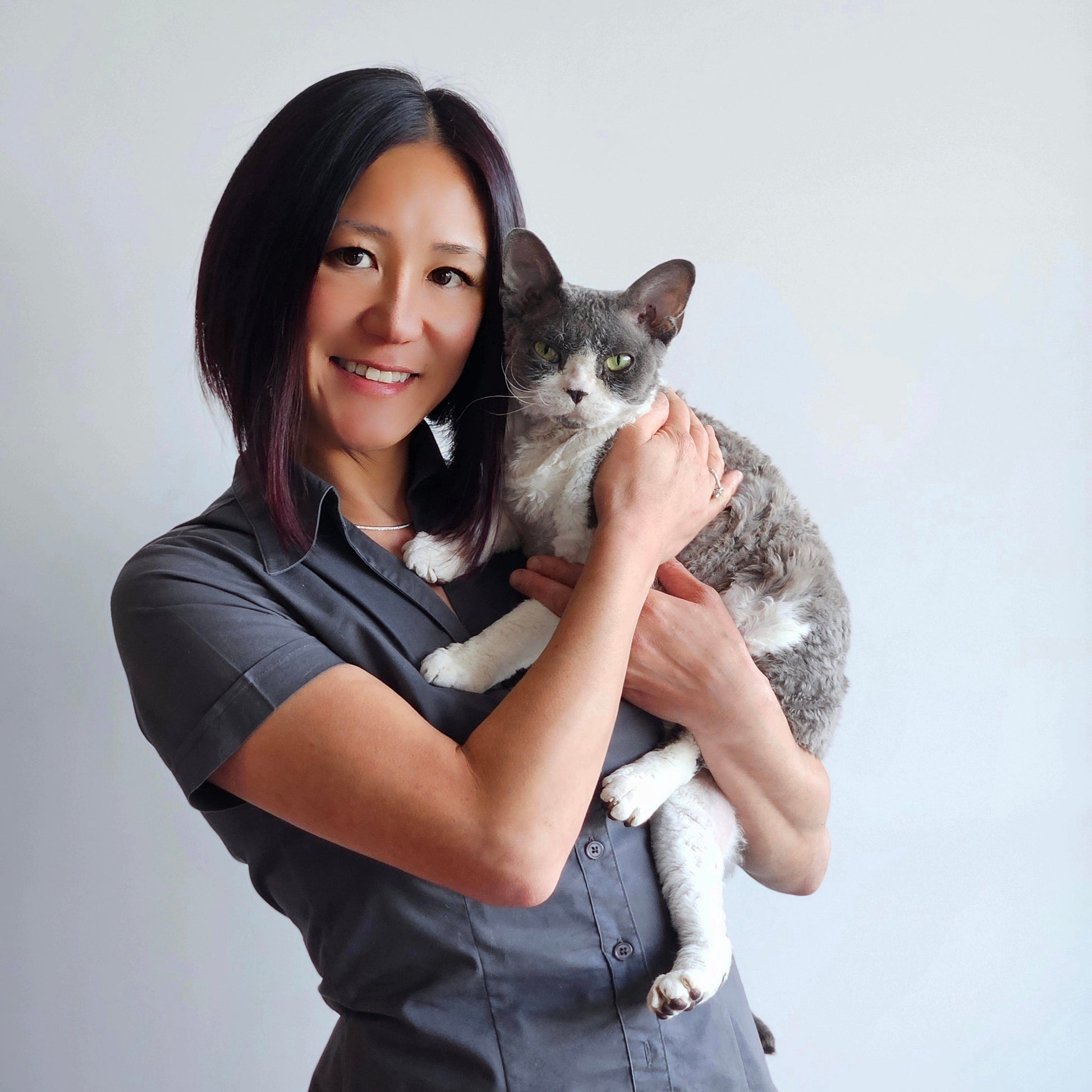 Best Fur Forward founder holding a gray and white cat against a plain background