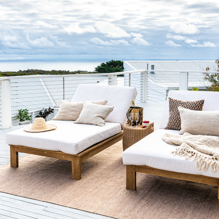 Zebra Home Fraser natural honey large outdoor area rug styled on a coastal pool deck under timber sun loungers.