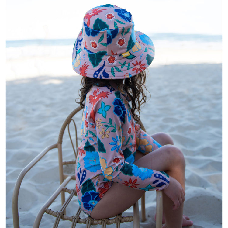 Girl wearing a Tyoub long sleeve one piece surfsuit in Phoenix at the beach.