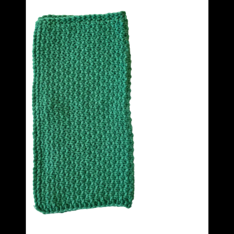 Green handmade knitted dishcloth made from absorbent recycled cotton, folded in half, for kitchen and bathroom use on a white background.
