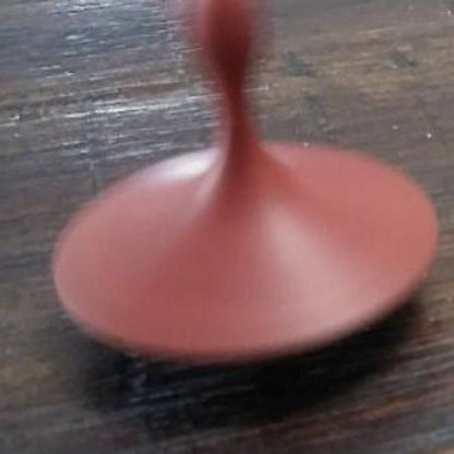 Hand-turned recycled timber spinning top with a warm oiled finish, handcrafted in Australia by Lyons Woodturning in use.