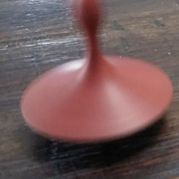 Hand-turned recycled timber spinning top with a warm oiled finish, handcrafted in Australia by Lyons Woodturning in use.