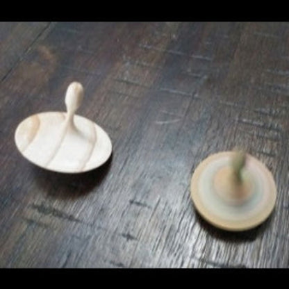Hand-turned recycled timber spinning top with a light unoiled finish, handcrafted in Australia by Lyons Woodturning.