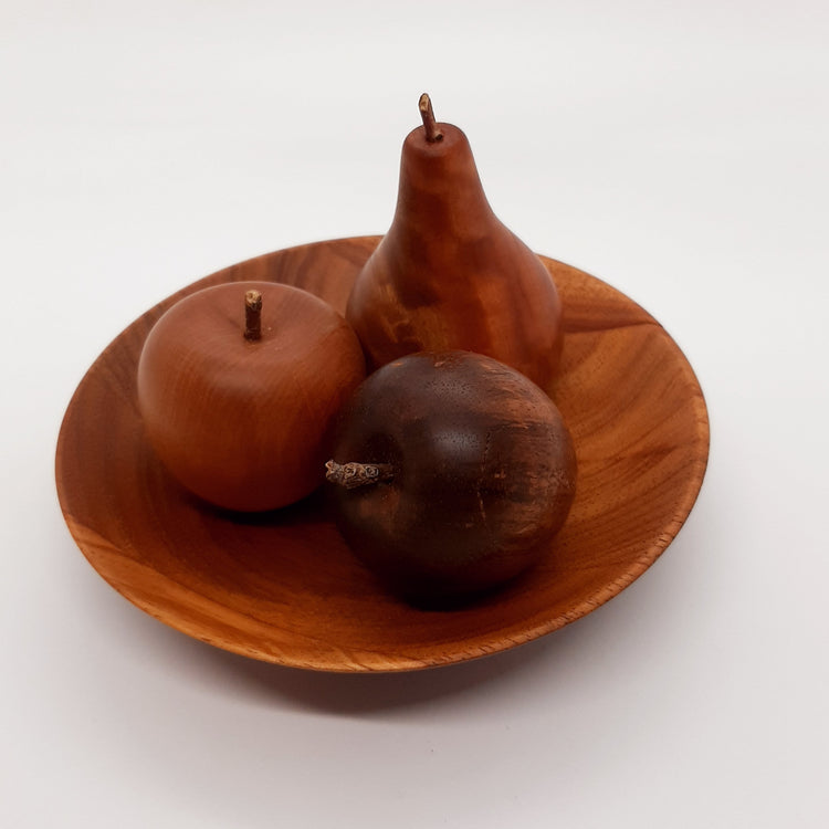 A hand-turned recycled timber decorative dish filled with three matching wooden fruit pieces, handcrafted in Australia by Lyons Woodturning.