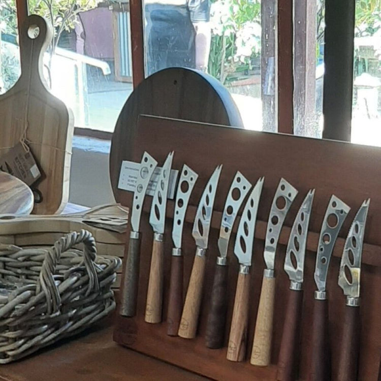 Row of  high-quality stainless steel cheese knives with a hand-turned recycled timber handle on a magnetic board, made by Lyons Woodturning in Jindera, New South Wales.