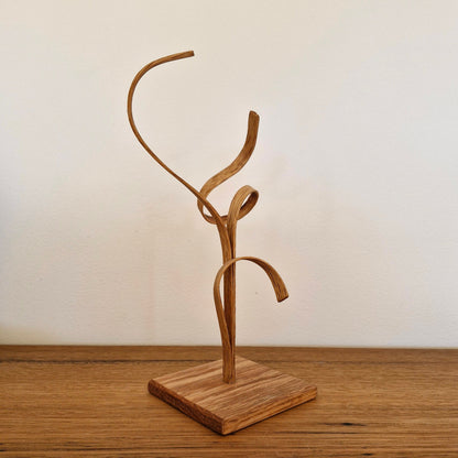 Back view of handcrafted American Oak sculpture showing organic steam-bent curves and natural wood grain.