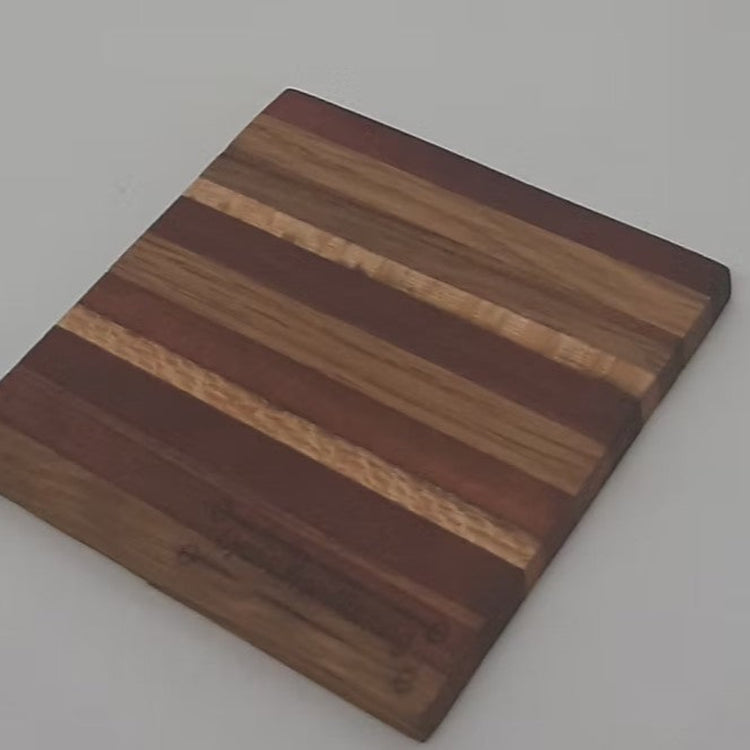 Close up of  one of a matching set of four handmade square recycled timber drink coasters handcrafted in Australia.