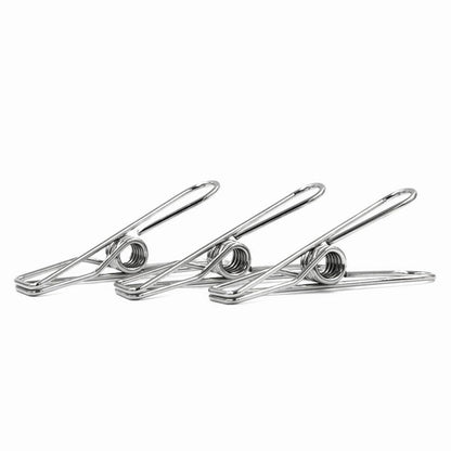 Close-up profile view of a three wire-formed rust-resistant stainless steel clothes peg displaying its ergonomic loop spring mechanics on a white background.