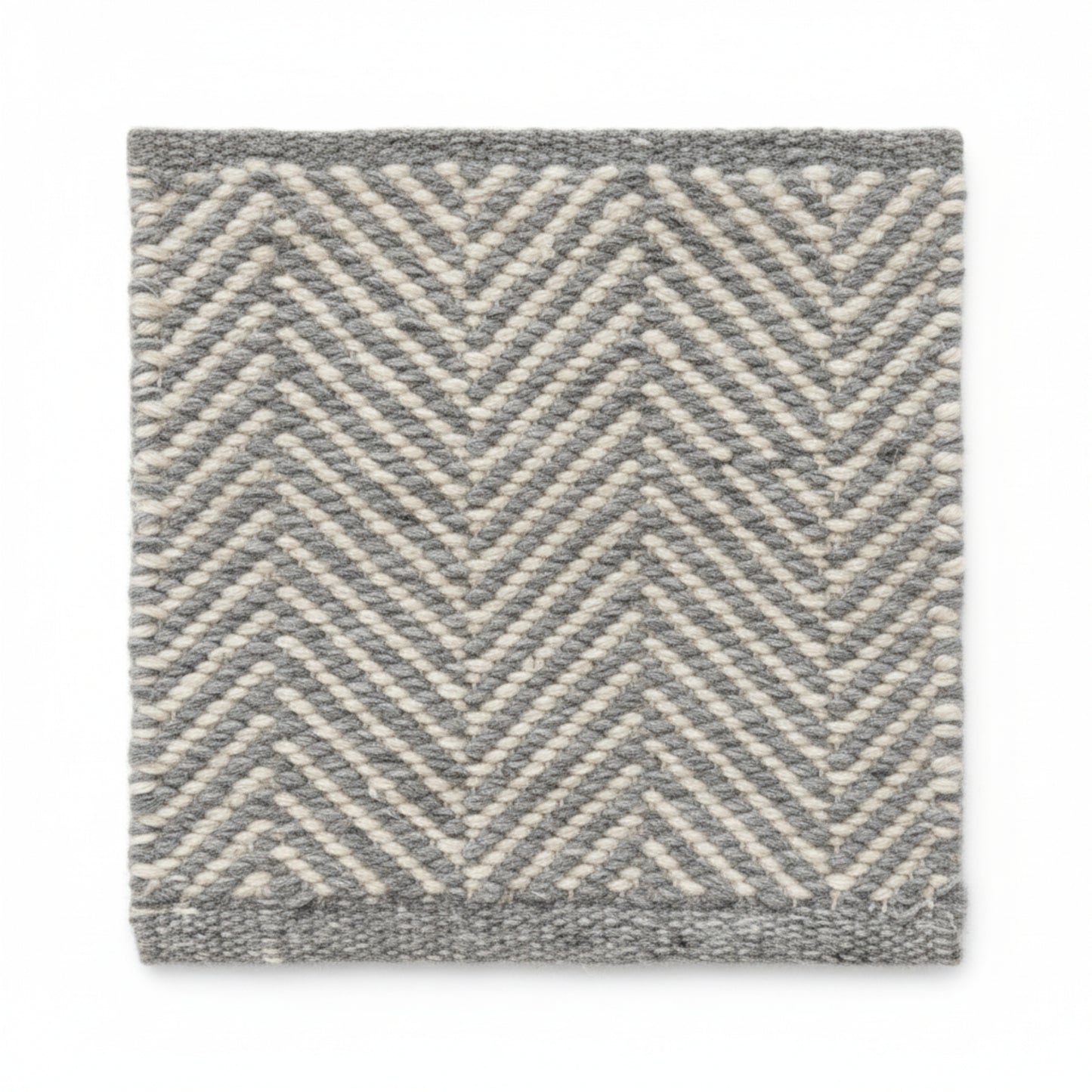 Close-up texture detail of the sustainable herringbone weave pattern on a Henshall grey recycled plastic floor mat.