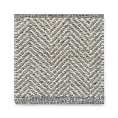 Close-up texture detail of the sustainable herringbone weave pattern on a Henshall grey recycled plastic floor mat.