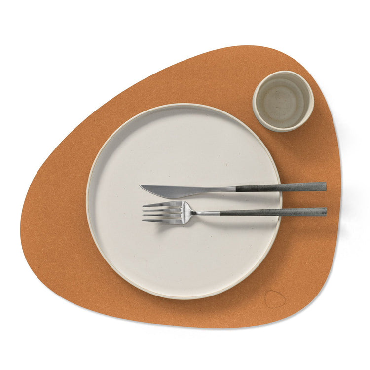 Curve recycled leather placemat featuring the signature LIND DNA Hippo  finish set with a plate, knife, fork and cup.