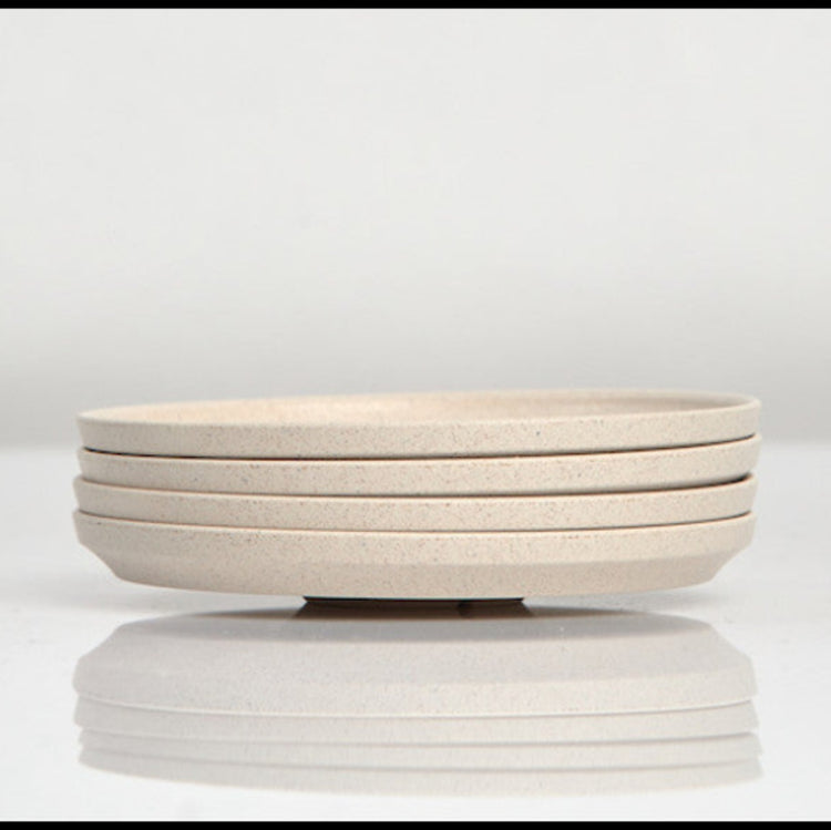 Pack of 4 Huskee small 3oz espresso saucers featuring the signature vertical ribbed design made from sustainable coffee husk waste side view In natural.