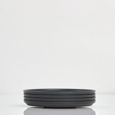 Pack of 4 universal Huskee Classic coffee saucers made from sustainable coffee husk waste in charcoal.