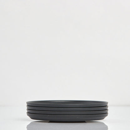 Pack of 4 universal Huskee Classic coffee saucers made from sustainable coffee husk waste in charcoal.