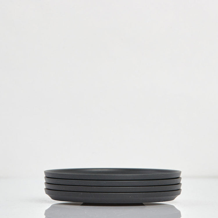 Pack of 4 universal Huskee Classic coffee saucers made from sustainable coffee husk waste in charcoal.