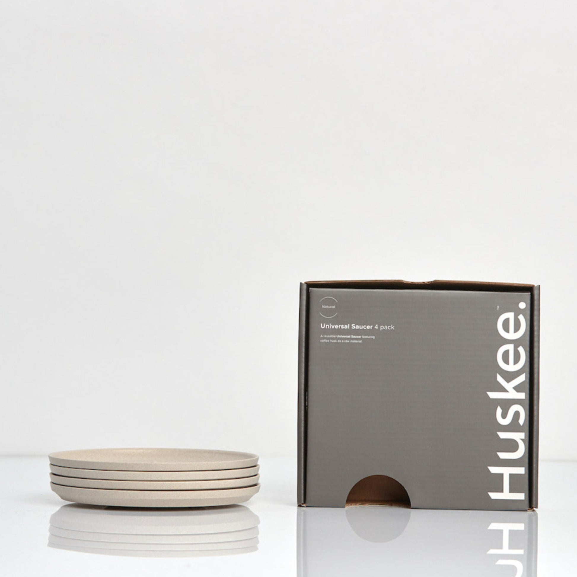 Pack of 4 universal Huskee Classic coffee saucers made from sustainable coffee husk waste with its box.