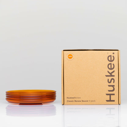 Pack of 4 translucent HuskeeRenew classic coffee saucers made from high-quality recycled polymers  in amber with box.