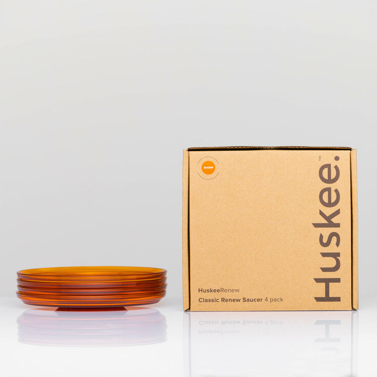 Pack of 4 translucent HuskeeRenew classic coffee saucers made from high-quality recycled polymers  in amber with box.