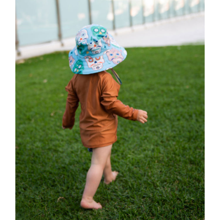 Young boy wearing the Tyoub long sleeve terracotta rash vest outdoors for sun smart UV protection in Australia.