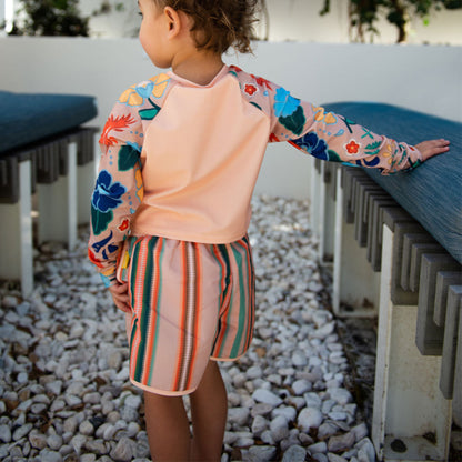 Side view of kids retro stripe swim trunks showing the flexible envelope side seam design for active water play.