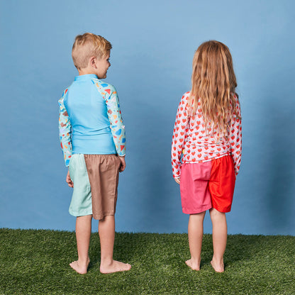 Rear profile of a child wearing the long sleeve strawberry swim shirt for sun smart UV protection in Australia.
