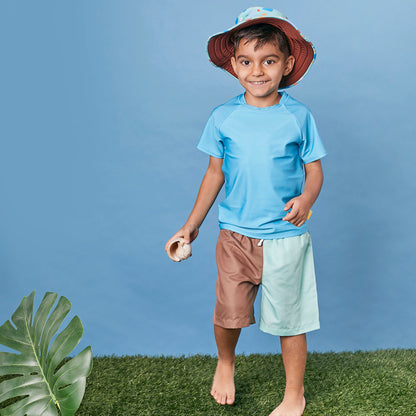 Child wearing Tyoub quick dry board shorts in mint slice and a matching rashie for sun smart UV protection in Australia.