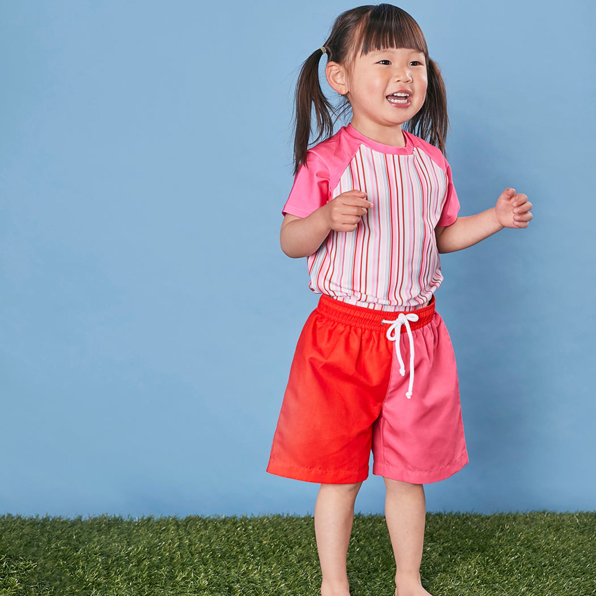 Child wearing Tyoub quick dry board shorts for Sun Smart UPF 50+ UV protection at an Australian beach.