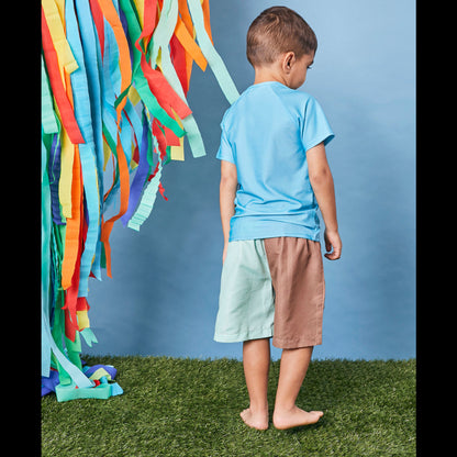 Back view of child wearing Tyoub quick dry board shorts in mint slice for smart UV protection in Australia.