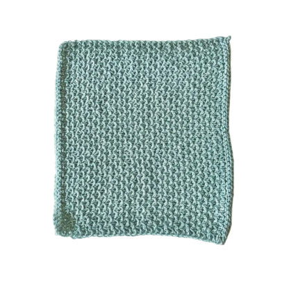 Light blue handmade knitted dishcloth made from absorbent recycled cotton for kitchen and bathroom use.