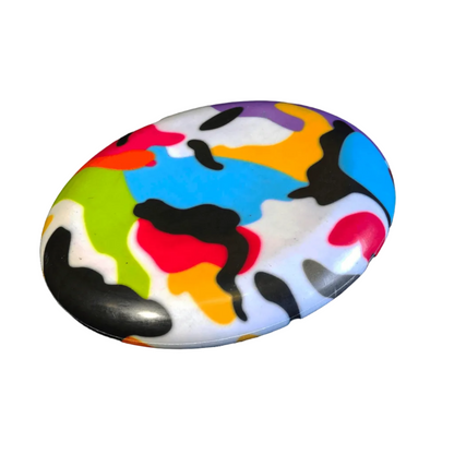 Standalone 230mm flying disc made from recycled Fijian beach waste showing vibrant, one-of-a-kind upcycled colour patterns in camo.
