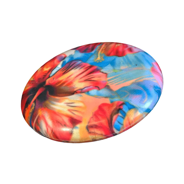 Standalone 230mm flying disc made from recycled Fijian beach waste showing vibrant, one-of-a-kind upcycled colour patterns in floral 1.