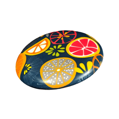 Standalone 230mm flying disc made from recycled Fijian beach waste showing vibrant, one-of-a-kind upcycled colour patterns in fruit.