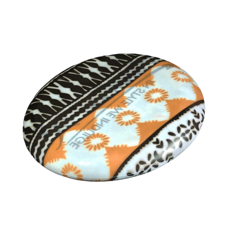 Standalone 230mm flying disc made from recycled Fijian beach waste showing vibrant, one-of-a-kind upcycled colour patterns in print brown.
